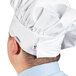 A man wearing a white Uncommon Chef poplin chef hat.