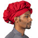A man wearing a red Uncommon Chef poplin chef hat.