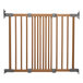 A L.A. Baby Beechwood angle mount safety gate with metal rods.