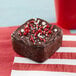 A square brownie with red sprinkles on top in the Wilton bite-size brownie pan.