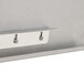 A close-up of a stainless steel Advance Tabco detachable drainboard with metal hooks.