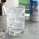 A glass of Polar Club Soda with ice cubes on a counter.