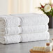 A stack of three white Lavex Premium bath sheets.