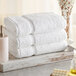 A stack of white Lavex bath towels.