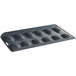 A black non-stick carbon steel Madeleine sheet pan with 12 shell-shaped molds.