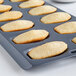 A Fox Run Madeleine sheet pan with cookies in it.