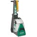 A Bissell Commercial BG10 carpet extractor with a green hose and button.