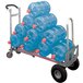 A Magliner hand truck with a stack of blue plastic water jugs on it.