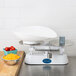 An Edlund baker's dough scale on a counter with a white bowl on it.