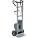 A Magliner heavy-duty hand truck with a red handle and wheels.