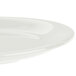 A Carlisle bone melamine salad plate with a narrow rim.