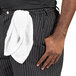 A man wearing Uncommon Chef pinstripe chef pants with a towel on his waist.