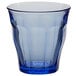 A clear glass tumbler with a blue tint and a clear rim.