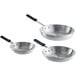 A group of three aluminum frying pans with black silicone handles.