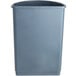 A close up of a gray Lavex half round trash can with a lid.