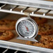 A CDN ProAccurate high-heat oven thermometer in an oven.