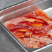 A metal tray with frozen Boston Lobster claw and knuckle meat.