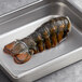 A Boston Lobster Company 8-10 oz. lobster tail in a metal pan.