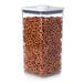 An OXO Good Grips clear square food storage container with a white lid filled with pretzels.