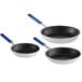 A group of three black Vollrath Wear-Ever frying pans with blue Cool Handles.