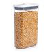 A OXO Good Grips rectangular food storage container with corn kernels inside.