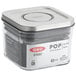 An OXO Good Grips square SAN plastic food storage container with a stainless steel lid.