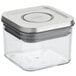 An OXO Good Grips clear square plastic food storage container with a silver lid.