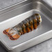 A Boston Lobster Company 7-8 oz. lobster tail in a metal pan.
