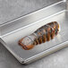 A metal tray with Boston Lobster Company 14-16 oz. lobster tails.