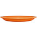 An orange stoneware platter with a narrow rim.