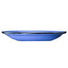 An International Tableware Campfire ocean blue stoneware saucer with a speckled rim.
