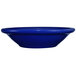 A white stoneware bowl with a blue rim.