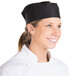A woman wearing a Chef Revival black mesh baker's skull cap.
