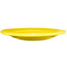A yellow International Tableware Cancun stoneware plate with a wide rim.