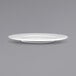 An International Tableware bright white porcelain plate with a small rim on a gray background.