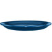 A light blue International Tableware stoneware platter with a narrow rim.