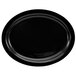 A black stoneware oval platter with a narrow rim.