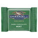 A close-up package of Ghirardelli dark chocolate mint squares.