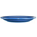 A light blue International Tableware stoneware plate with a narrow rim.