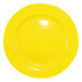 A yellow stoneware plate with a white rim and white background.