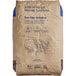A brown ADM Premium Whole Wheat Flour bag with blue text.