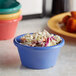 A bowl of coleslaw sits in a pink, red, and green Elite Global Solutions melamine ramekin on a table.