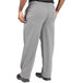 Uncommon Chef women's houndstooth chef pants with pockets and a zipper worn by a person with hands in pockets.