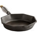 A pre-seasoned black cast iron skillet with a metal handle.