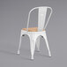 A Lancaster Table & Seating white chair with a natural wood seat.