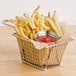 A basket of french fries with ketchup.