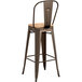 A Lancaster Table & Seating copper metal barstool with natural wood seat.