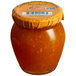 A Dalmatia jar of tangerine spread with a white label.
