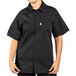 A person wearing a black Uncommon Chef short sleeve cook shirt with full mesh back.