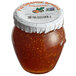 A case of 12 Dalmatia Fig Spread with Fresh Orange jars with white lids on a table in a deli.